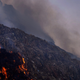 A man walks through the Bhalswa landfill as the fire rages.